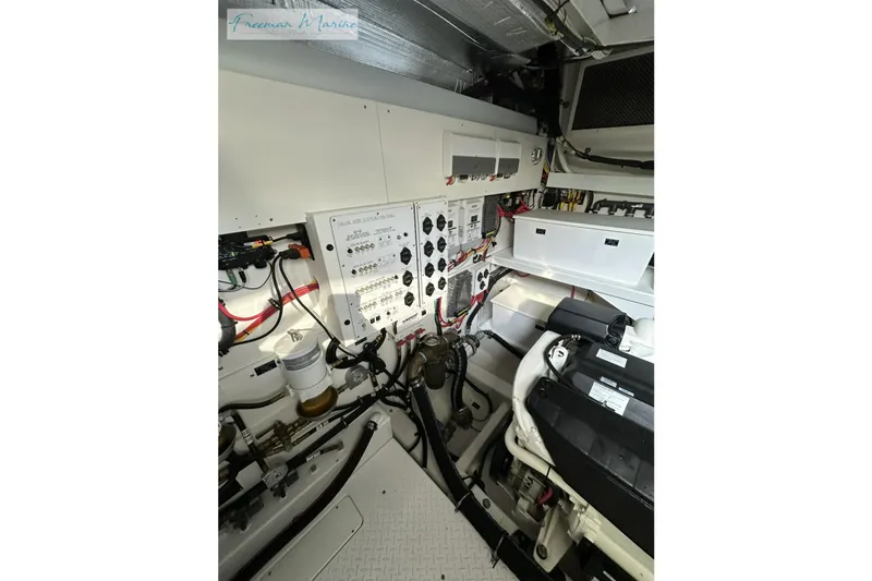 Slide: The Image of Engine room of 2022 Cruisers Yachts 60 Cantius, showcasing control panels and wiring. - 61