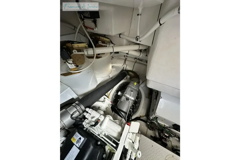 Slide: The Image of Engine room of 2022 Cruisers Yachts 60 Cantius, showcasing mechanical components and piping. - 62