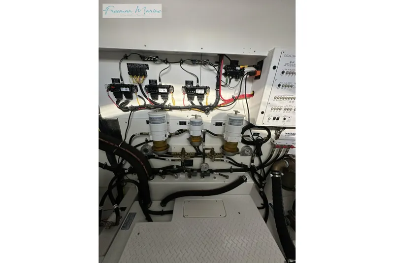 Slide: The Image of Engine room of 2022 Cruisers Yachts 60 Cantius with wiring and filters visible. - 67