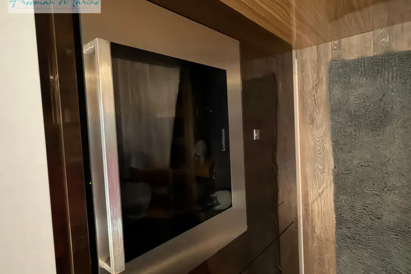 Slide: The Image of Built-in refrigerator on 2022 Cruisers Yachts 60 Cantius, featuring sleek stainless steel design. - 81