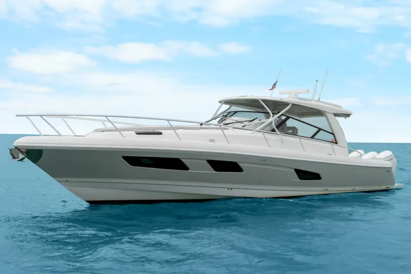 The Image of 2024 Intrepid 477 Evolution yacht on calm blue ocean under clear sky. - 0