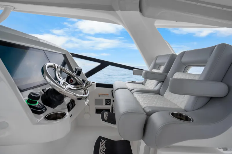 Slide: The Image of 2024 Intrepid 477 Evolution helm with modern controls and luxurious seating. - 11