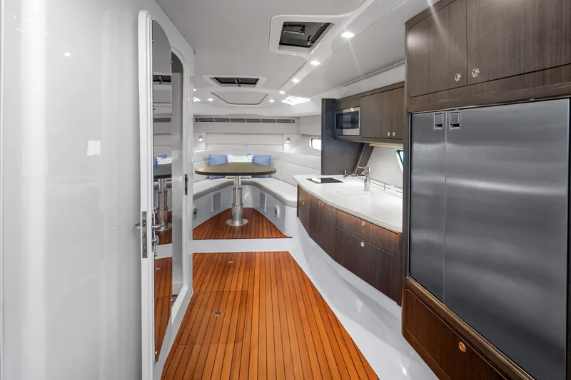 Slide: The Image of Luxurious interior of 2024 Intrepid 477 Evolution yacht with modern kitchen and seating area. - 13