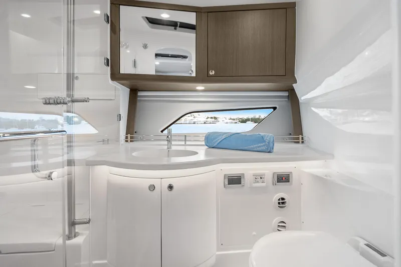 Slide: The Image of Luxurious bathroom interior of 2024 Intrepid 477 Evolution yacht, featuring modern fixtures and sleek design. - 17