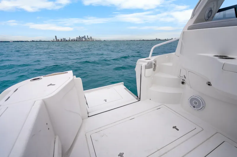 Slide: The Image of 2024 Intrepid 477 Evolution boat with city skyline in the background. - 31