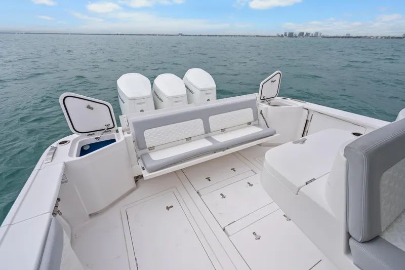 Slide: The Image of 2024 Intrepid 477 Evolution boat deck with seating and storage, ocean view. - 33