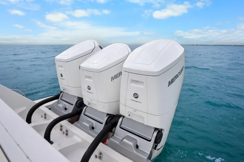 Slide: The Image of Triple Mercury Verado engines on 2024 Intrepid 477 Evolution boat in open sea. - 34