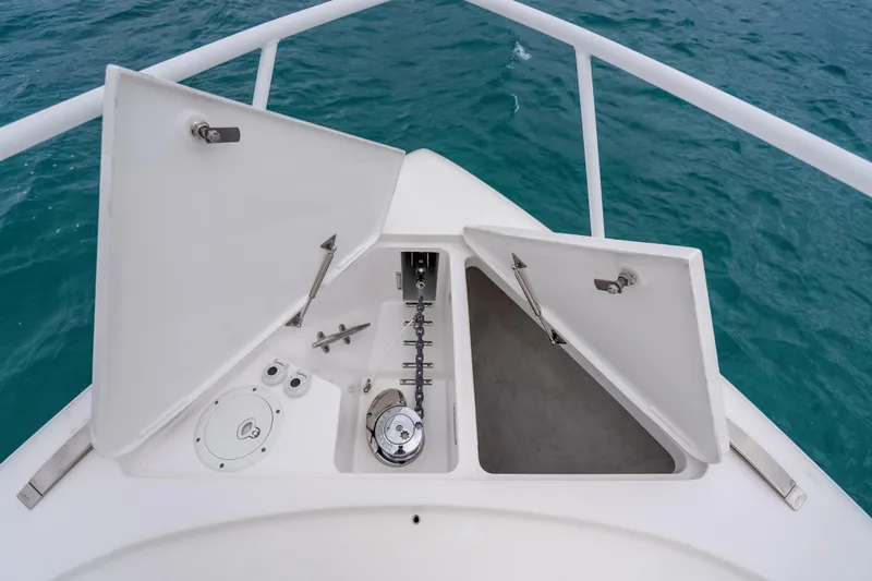 Slide: The Image of Bow view of 2024 Intrepid 477 Evolution with open anchor storage compartments. - 36