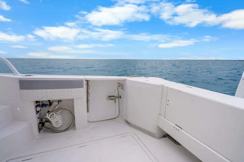 Slide: The Image of 2024 Intrepid 477 Evolution boat deck with ocean view and blue sky. - 37