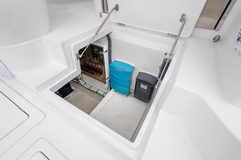 Slide: The Image of 2024 Intrepid 477 Evolution boat storage compartment with electrical components. - 39