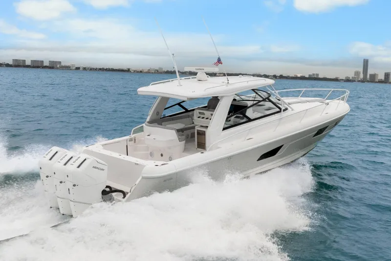 Slide: The Image of 2024 Intrepid 477 Evolution yacht cruising on open water, showcasing sleek design and powerful engines. - 5