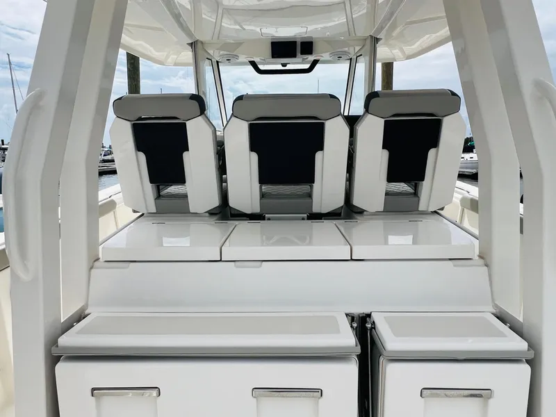 Slide: The Image of 2022 Pursuit S 358 Sport boat interior with sleek seating and storage compartments. - 19
