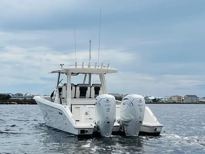 Slide: The Image of 2022 Pursuit S 358 Sport boat with dual engines on open water. - 2