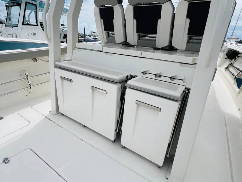 Slide: The Image of 2022 Pursuit S 358 Sport boat interior with seating and storage compartments. - 20