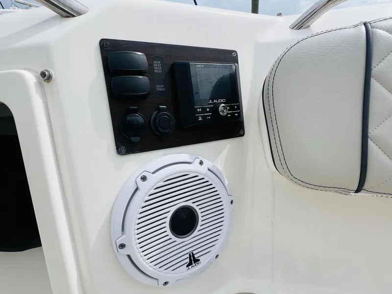Slide: The Image of 2022 Pursuit S 358 Sport boat console with audio controls and speaker. - 27