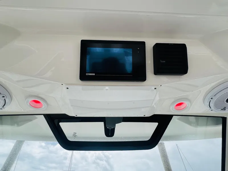 Slide: The Image of 2022 Pursuit S 358 Sport boat dashboard with electronic display and speakers. - 32