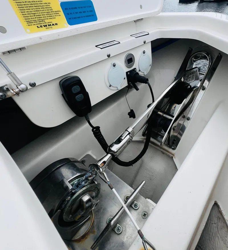 Slide: The Image of 2022 Pursuit S 358 Sport boat anchor compartment with control panel and winch system. - 35
