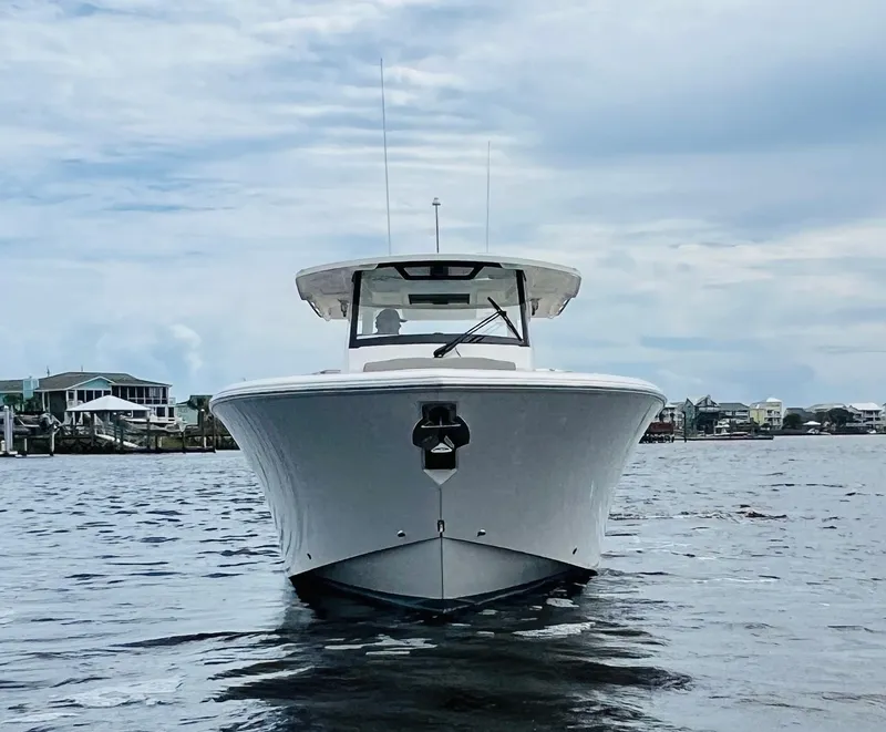 Slide: The Image of 2022 Pursuit S 358 Sport boat on water, front view. - 4