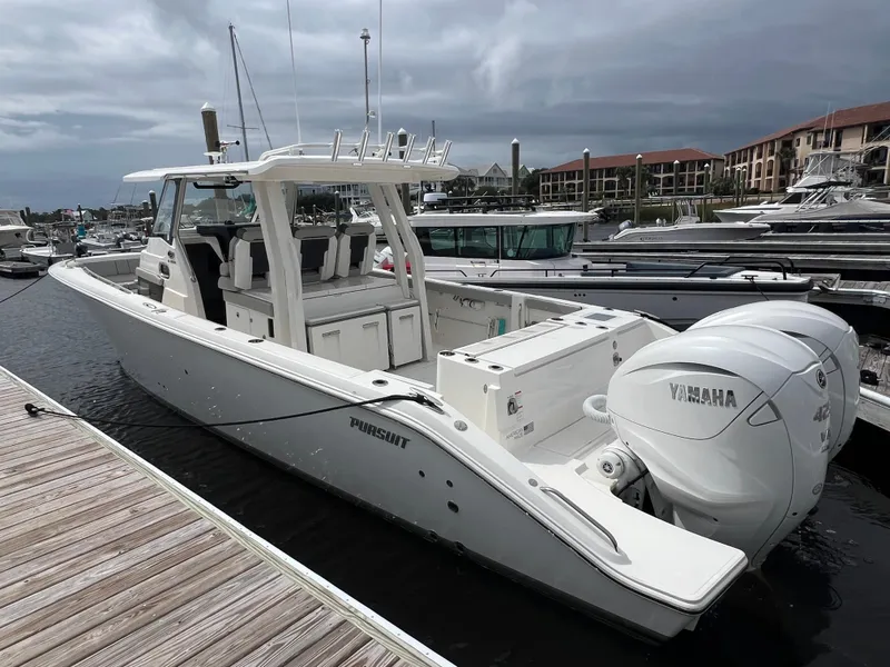 Slide: The Image of 2022 Pursuit S 358 Sport boat docked with twin Yamaha engines. - 6