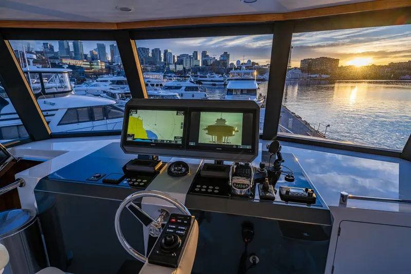 Slide: The Image of Pilothouse of 2017 Ocean Alexander 72 yacht with marina and sunset view. - 13