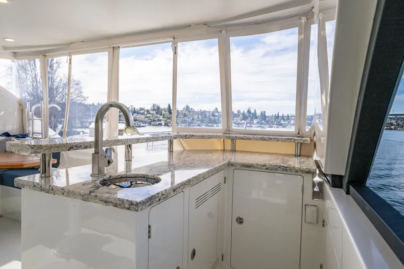 Slide: The Image of Luxurious interior of 2017 Ocean Alexander 72 Pilothouse yacht with granite countertops and scenic views. - 17