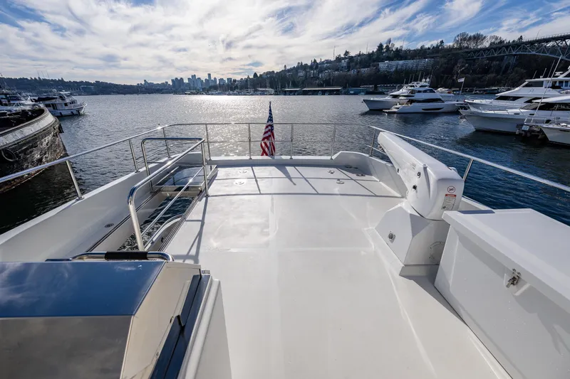 Slide: The Image of 2017 Ocean Alexander 72 Pilothouse yacht deck with scenic waterfront view. - 20