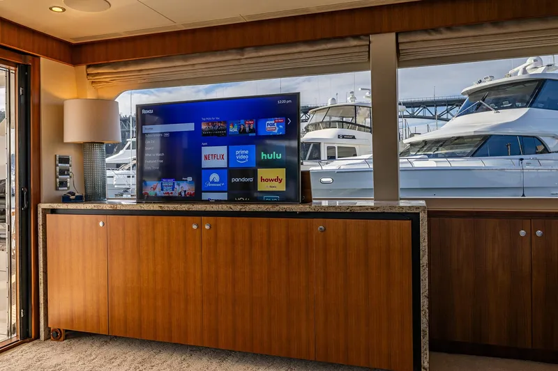 Slide: The Image of Luxurious interior of 2017 Ocean Alexander 72 Pilothouse yacht with TV and marina view. - 29