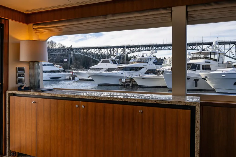 Slide: The Image of Interior view from 2017 Ocean Alexander 72 Pilothouse, overlooking marina with yachts and bridge. - 30