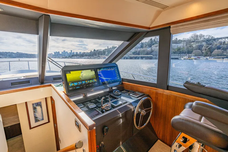 Slide: The Image of Pilothouse interior of 2017 Ocean Alexander 72, featuring navigation screens and waterfront view. - 34