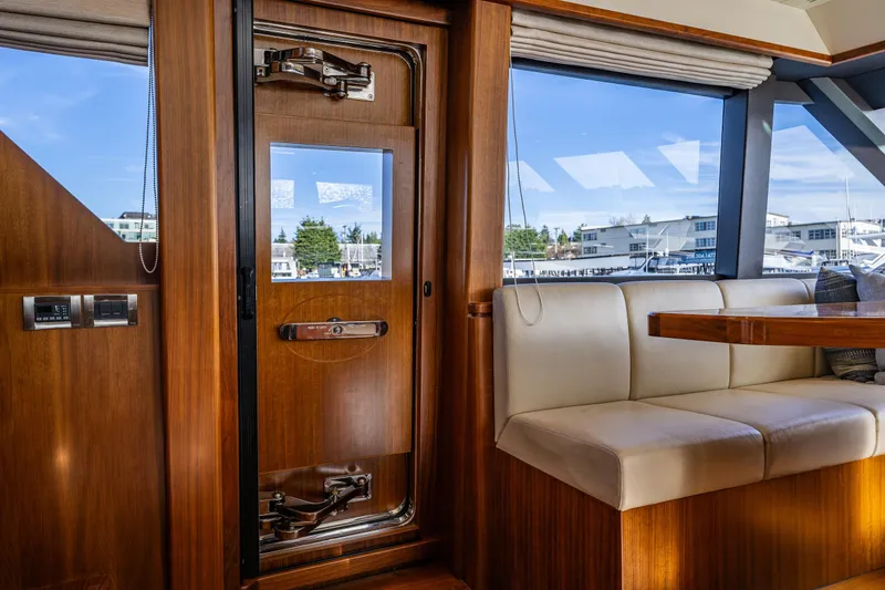 Slide: The Image of Interior of 2017 Ocean Alexander 72 Pilothouse yacht with wooden door and seating area. - 36