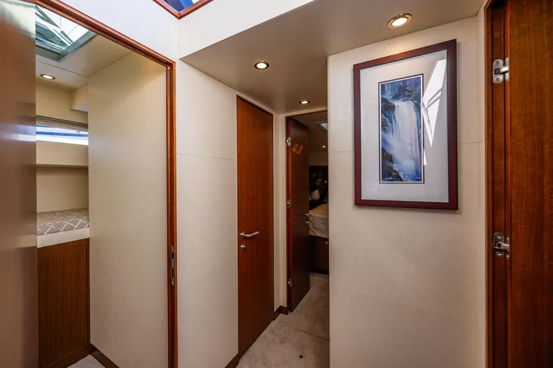 Slide: The Image of Interior hallway of 2017 Ocean Alexander 72 Pilothouse yacht with framed artwork. - 46