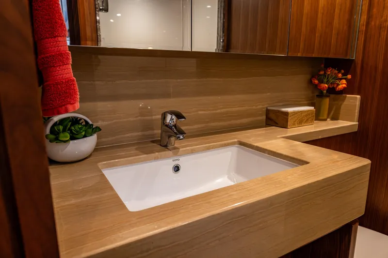 Slide: The Image of Luxurious bathroom sink in 2017 Ocean Alexander 72 Pilothouse yacht, featuring elegant wood accents. - 51