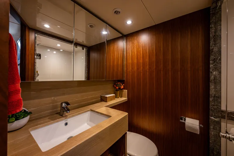 Slide: The Image of Luxurious bathroom in 2017 Ocean Alexander 72 Pilothouse yacht with wood accents and modern fixtures. - 56