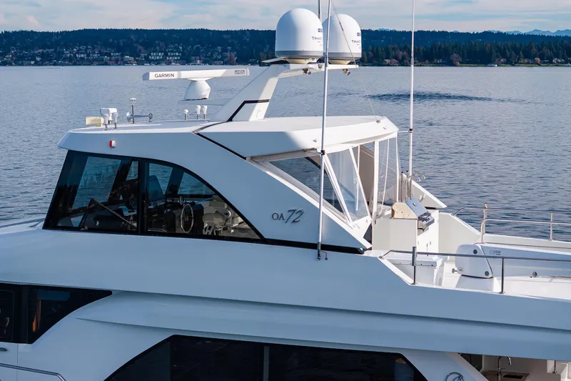 Slide: The Image of 2017 Ocean Alexander 72 Pilothouse yacht on calm water, featuring sleek design and advanced navigation equipment. - 6