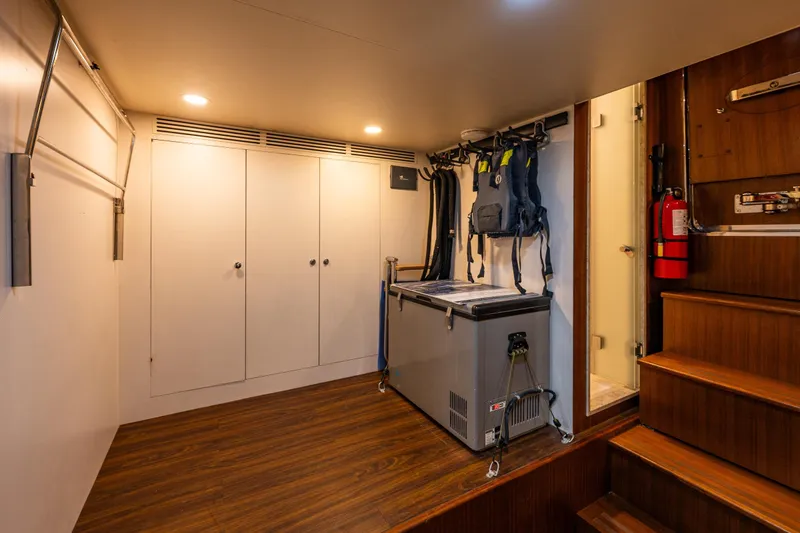 Slide: The Image of Utility room in 2017 Ocean Alexander 72 Pilothouse with storage, freezer, and life jackets. - 61