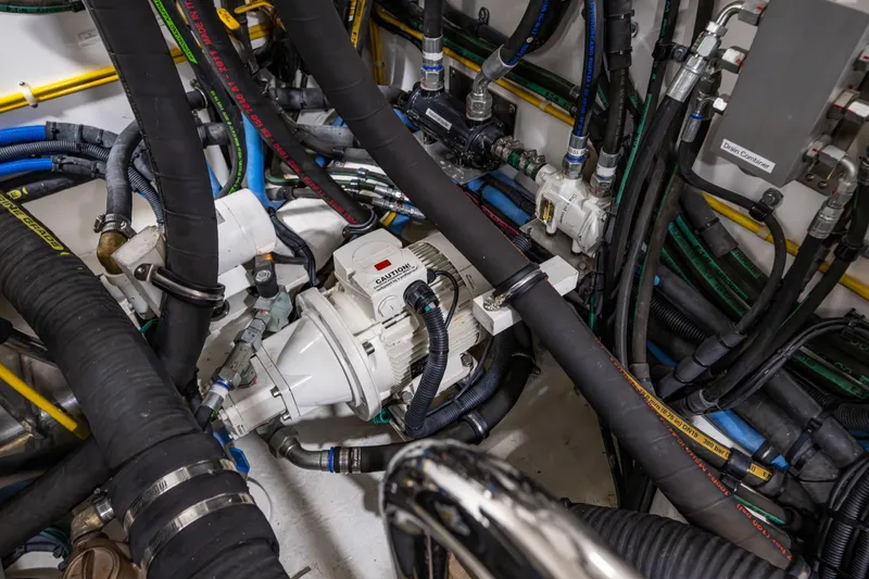 Slide: The Image of Engine room of 2017 Ocean Alexander 72 Pilothouse with complex hose and pump system. - 69