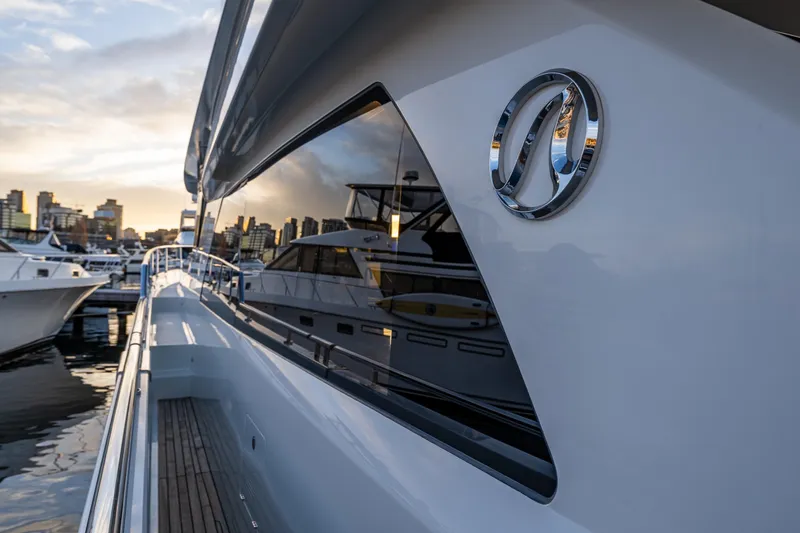 Slide: The Image of 2017 Ocean Alexander 72 Pilothouse yacht docked at sunset, city skyline in background. - 9