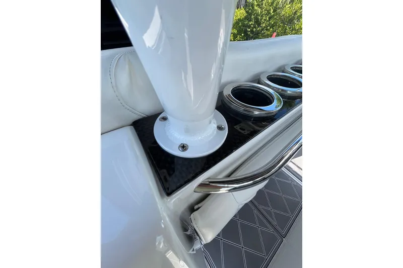Slide: The Image of 2019 Nor-Tech 390 Sport Center Console boat detail with cup holders and sleek design. - 12