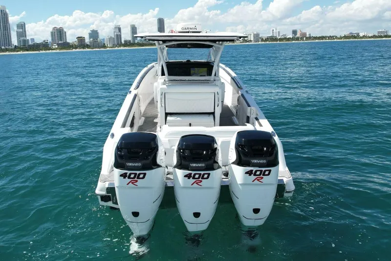 Slide: The Image of 2019 Nor-Tech 390 Sport Center Console with triple Mercury 400R engines on the water. - 2