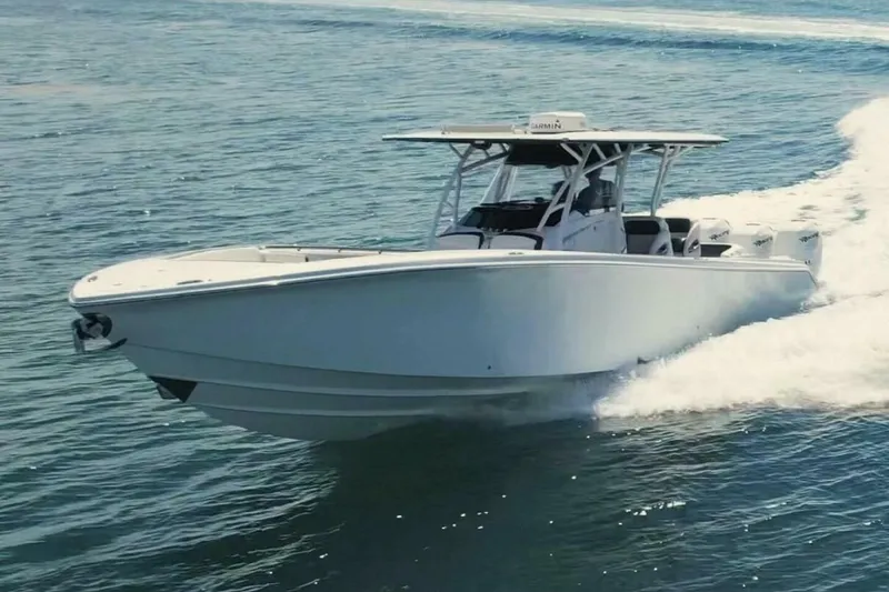 Slide: The Image of 2019 Nor-Tech 390 Sport Center Console boat cruising on open water. - 4