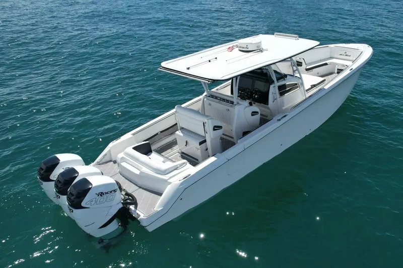 Slide: The Image of 2019 Nor-Tech 390 Sport Center Console boat on clear blue water. - 6