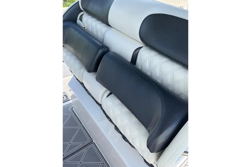 Slide: The Image of Luxury seating on 2019 Nor-Tech 390 Sport Center Console boat, featuring black and white upholstery. - 8