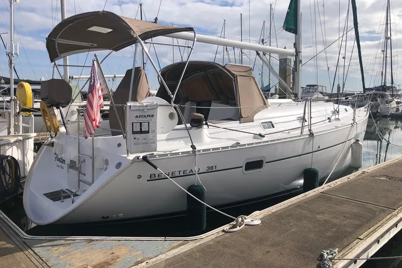 The Image of 2003 Beneteau 361 sailboat docked at marina, featuring a sleek white design. - 0