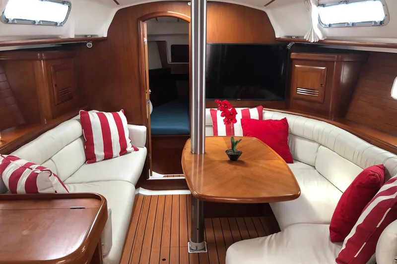 Slide: The Image of Interior of 2003 Beneteau 361 yacht with cozy seating and striped cushions. - 1