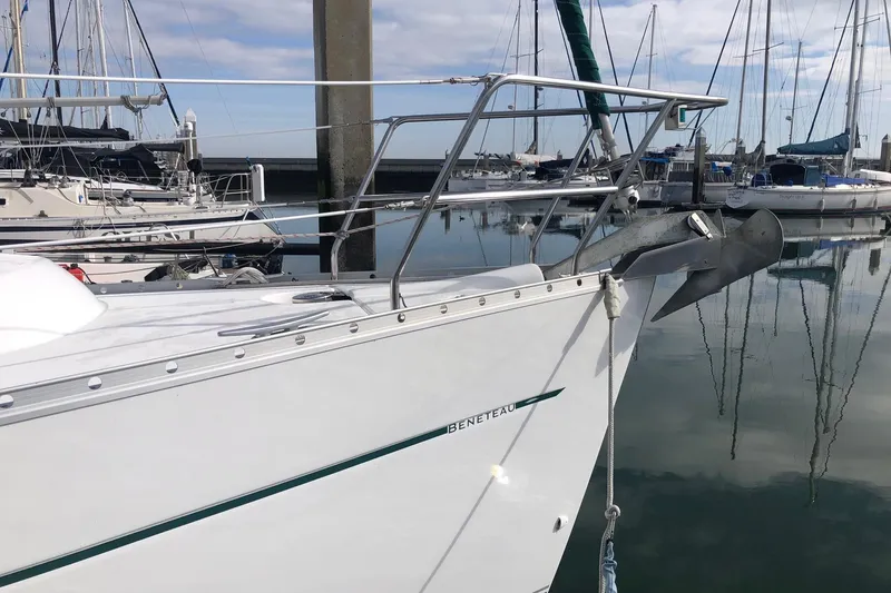 Slide: The Image of 2003 Beneteau 361 sailboat docked in a marina, featuring sleek design and anchor. - 14