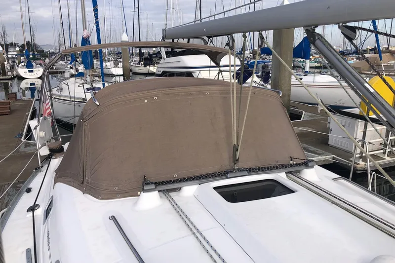 Slide: The Image of 2003 Beneteau 361 sailboat docked at marina with covered cockpit. - 18