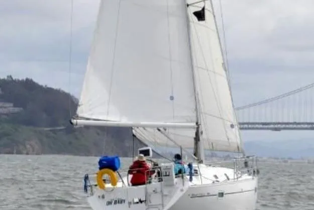 Slide: The Image of Sailing yacht Beneteau 361, 2003 model, cruising on open water near a bridge. - 20