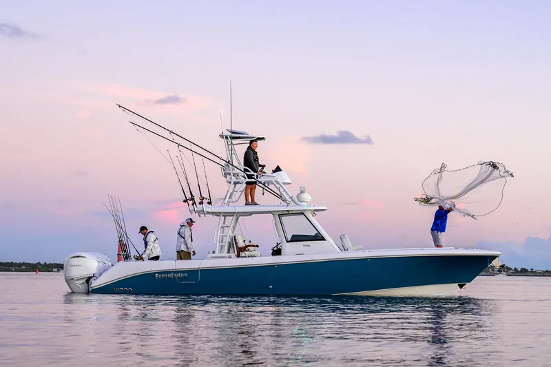 The Image of Manufacturer Provided Image: 2025 Everglades 375 Center Console fishing boat on calm water at sunset. - 0
