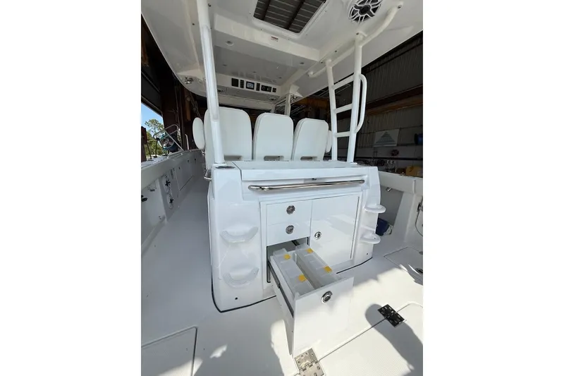 Slide: The Image of 2026 Everglades 375 Center Console interior with white seating and storage compartments. - 12