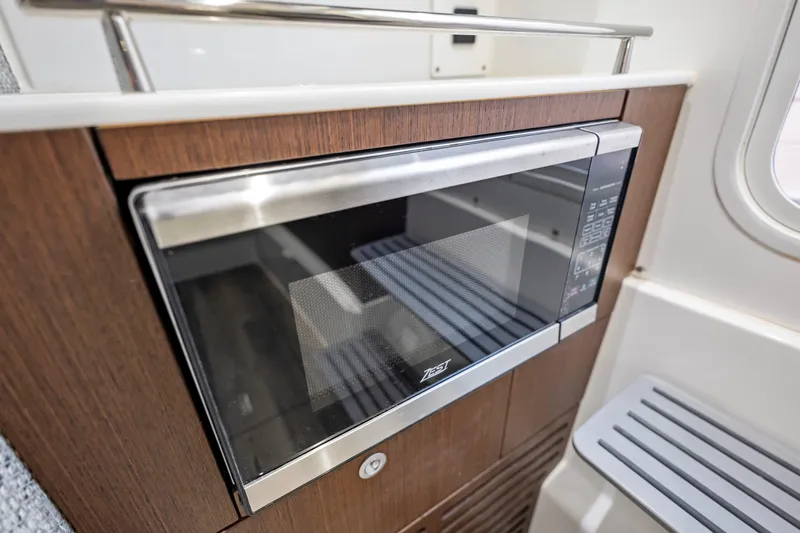 Slide: The Image of Built-in microwave in 2026 Everglades 375 Center Console boat interior. - 18